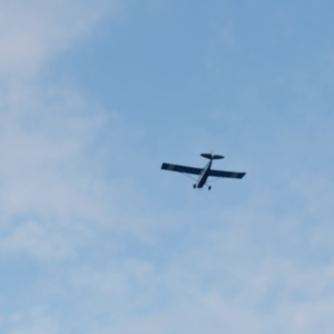 A bush plane flying in the sky.
